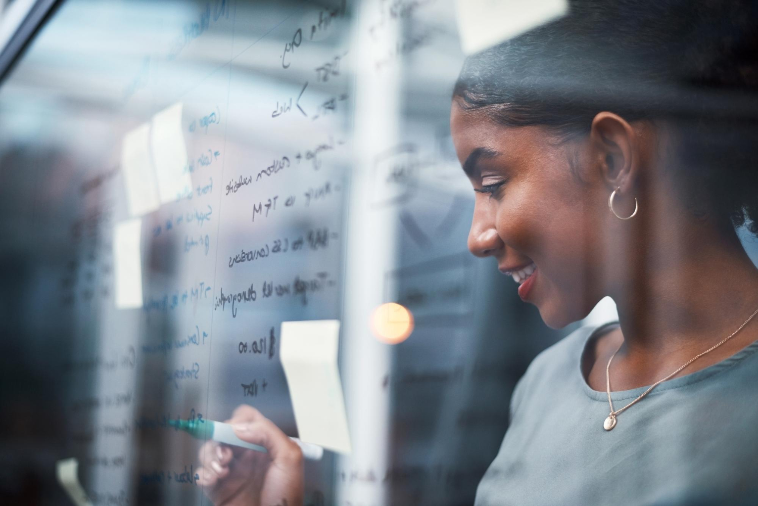 How to Win Where Your Competitor Is Winning: 7 Key Practical Strategies To Stay Ahead 2 a young woman writing on a glass board with a marker